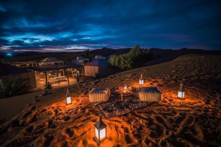 Desert camel caravan at sunset during a 7-day private Morocco tour from Agadir to Marrakech