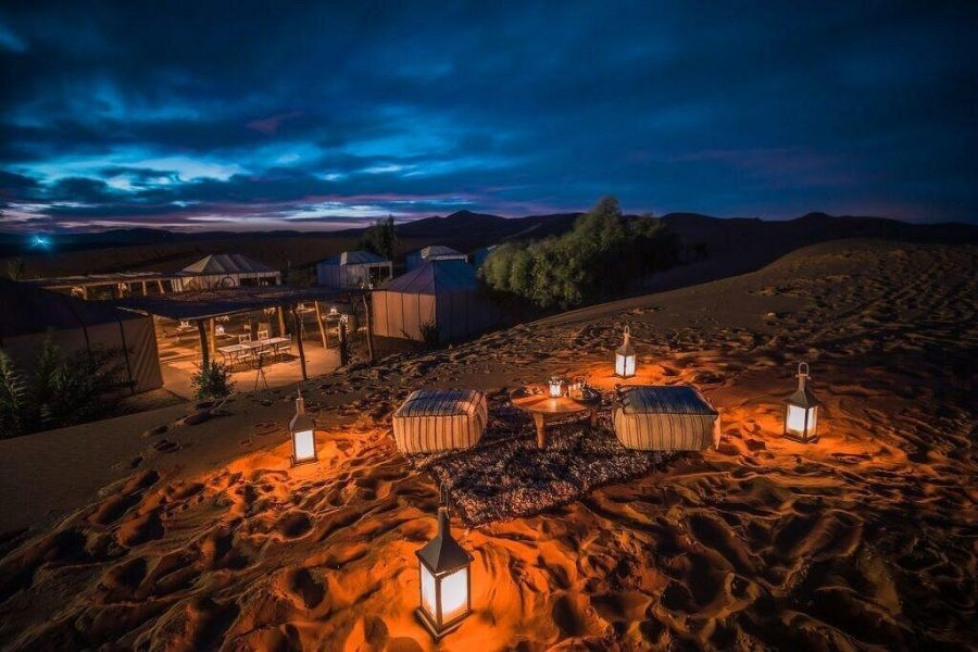 Desert camel caravan at sunset during a 7-day private Morocco tour from Agadir to Marrakech